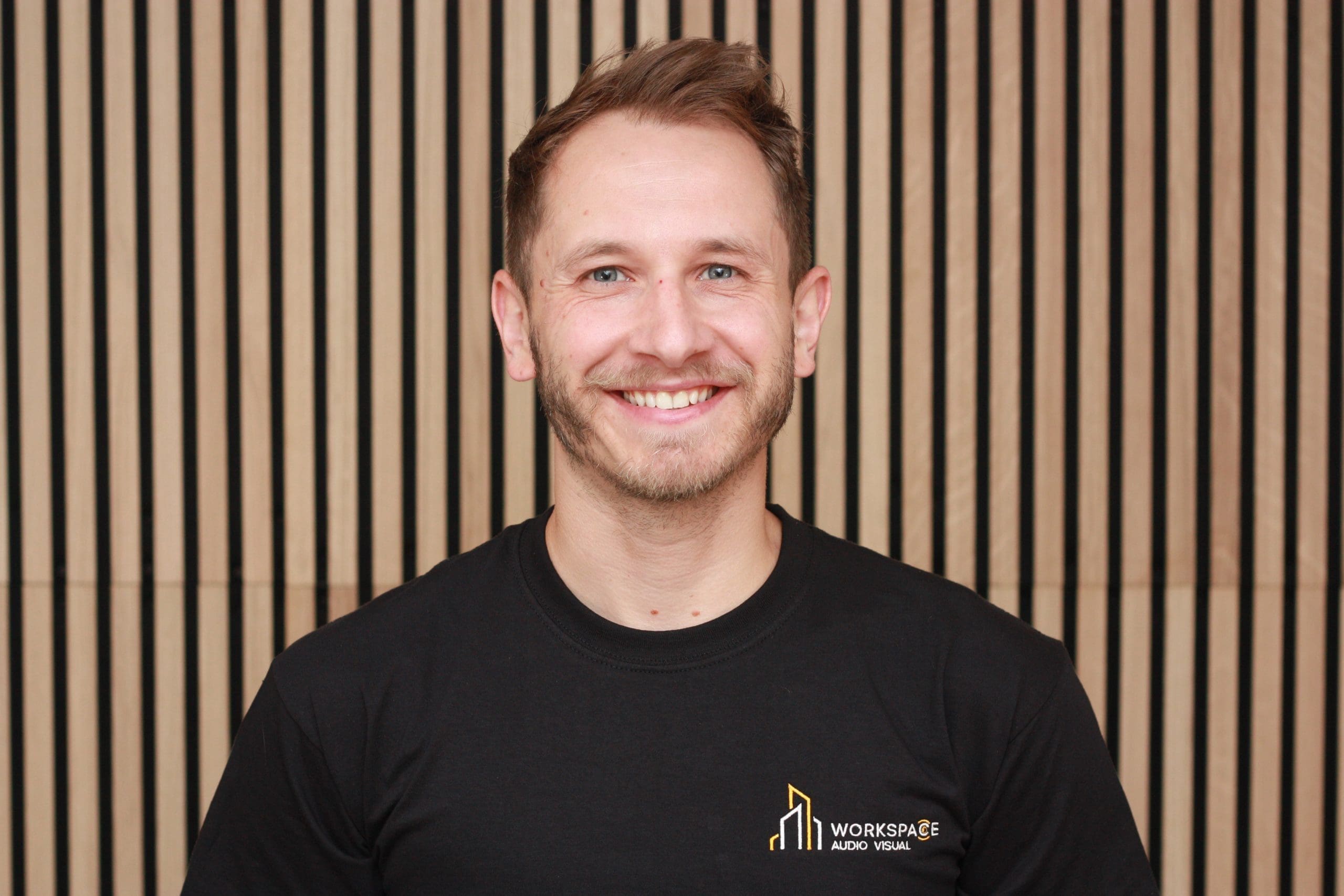 man standing in front of a striped wall